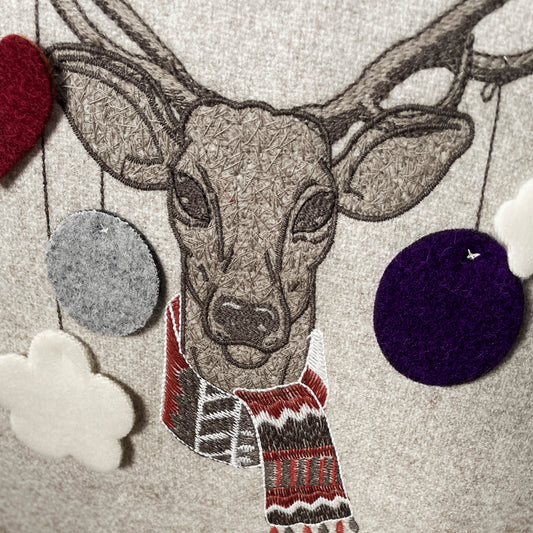 Melange wool cushion with cheerful deer embroidery