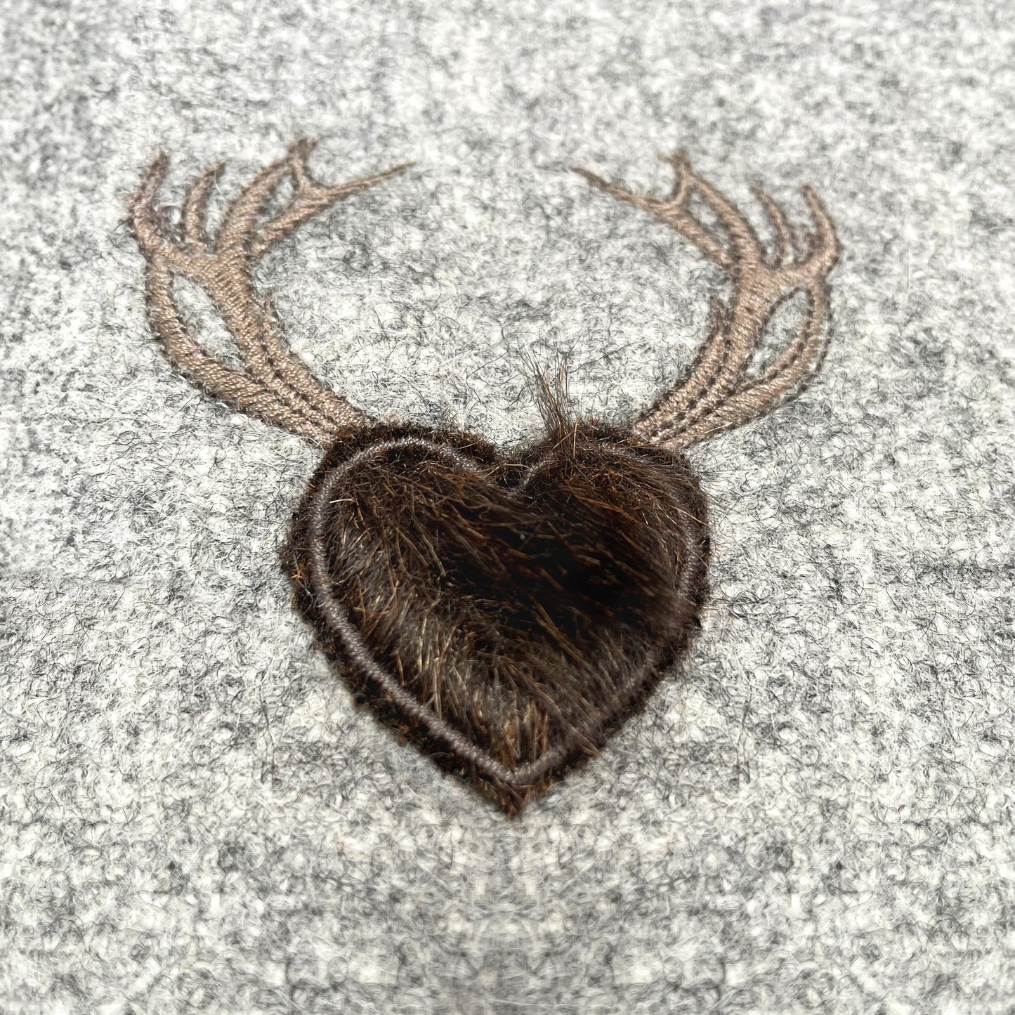 Melange wool cushion with fir embroidery